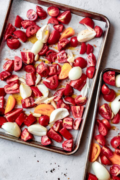 Tomatoes and onions on a sheet pan