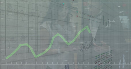 Image of financial data processing over diverse business people in office