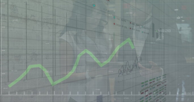 Image of financial data processing over diverse business people in office