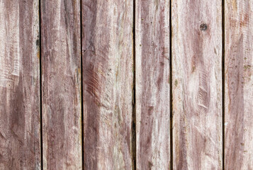 A wooden board with a grainy texture and a faded color