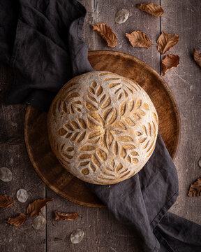 Round loaf of bread scored with a decorative pattern