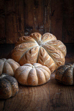 Pumpkin shaped bread loaves against a rustic background
