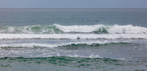 The ocean is calm and the water is a beautiful shade of green