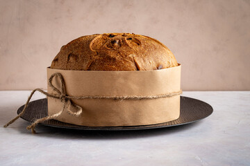 Artisanal panettone, set against a light background, a symbol of Catholic Christmas tradition. Front view..