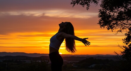 Fototapeta premium Silhouette of Woman at Sunset Freedom, Peace, and Serenity