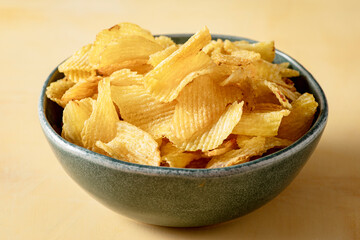Bowl that holds golden and crispy chips fries.