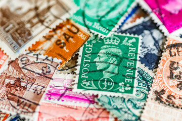 Postage stamps.A collection of world stamps in a pile.Postage stamps from different countries and times
