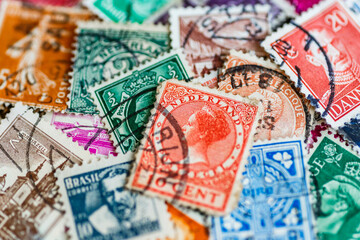Postage stamps.A collection of world stamps in a pile.Postage stamps from different countries and...