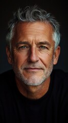 Fototapeta premium A man with a beard and gray hair is smiling