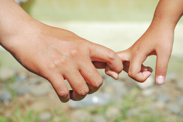 hands holding fingers in the morning sunny on blurred background