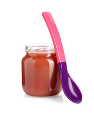 Baby food. Tasty puree in glass jar and spoon isolated on white