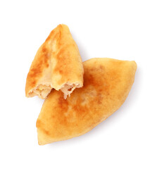 Whole and bitten fried pyrizhky (stuffed pies) isolated on white