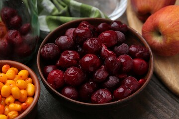 Tasty cherries, sea buckthorn berries and apples on wooden table, closeup