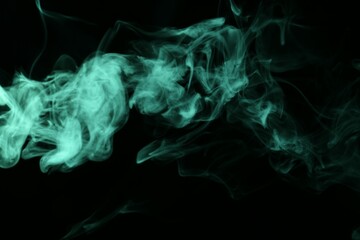 Beautiful smoke in green light on dark background