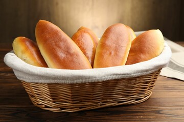 Tasty baked patties on wooden table, closeup