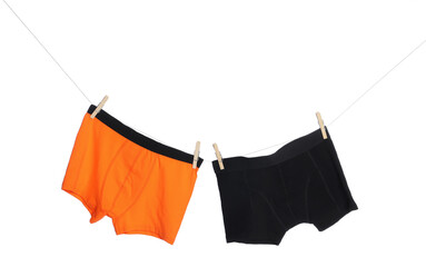 Comfortable men's underwear on clothes line against white background