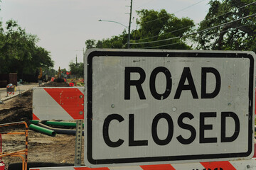 Road Closure With Barriers at Construction Site in Urban Residential Area. Street construction site...