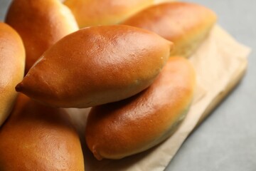 Tasty baked patties on light grey table, closeup