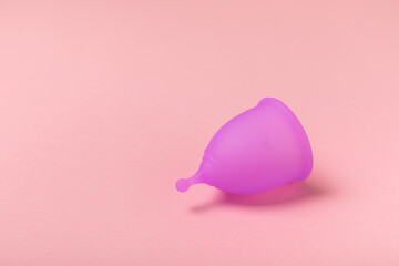 Menstrual cup on a bright background. Sanitary napkins, tampons and menstrual cup.Concept of...