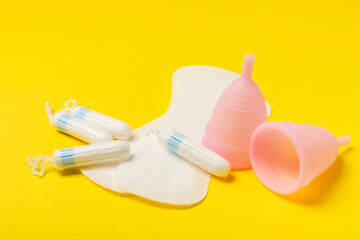 Menstrual cup on a bright background. Sanitary napkins, tampons and menstrual cup.Concept of critical days, menstruation.feminine hygiene product. Women health concept.Premenstrual syndrome.Copy space