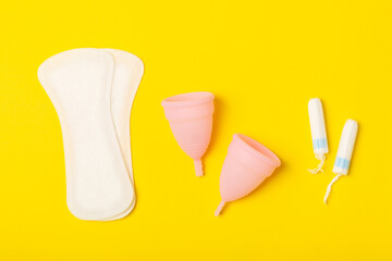 Menstrual cup on a bright background. Sanitary napkins, tampons and menstrual cup.Concept of...