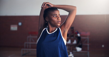 Black woman, basketball or stretching with arms for game, match or sport competition on court. Female person, African player or athlete getting ready with warm up or preparation for serious challenge