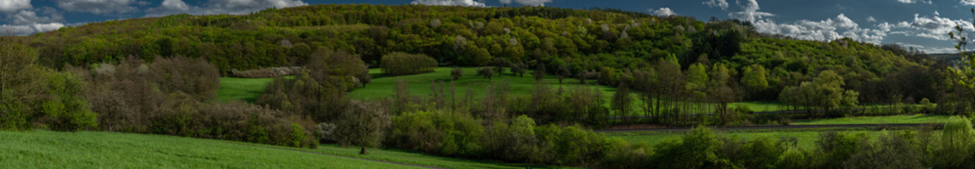 Panorama view for railway with green spring hills near Biskupice village