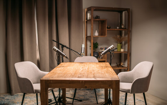 A podcast studio room with professional cameras, microphones and lighting fixtures. Audio and video podcast studio with equipment. No one.