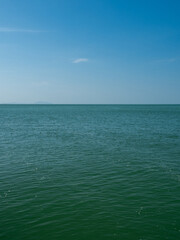 Obraz premium Photography landscape beautiful summer vertical horizon look view shore open sea beach cloud clean and blue sky background calm nature ocean wave water nobody travel at thailand chonburi sun day time