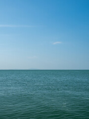 Obraz premium Photography landscape beautiful summer vertical horizon look view shore open sea beach cloud clean and blue sky background calm nature ocean wave water nobody travel at thailand chonburi sun day time