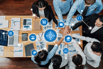 Plakat A top-down view of a business meeting showcasing teamwork and strategy with modern technology, data analysis tools, and collaborative interaction in a dynamic office setting. Amity