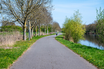 Cycling lane along the river Lys or Leie in Wevelgem, West Flanders, Belgium