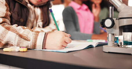Science, hands and child with writing in classroom for microscopic experiment, biology education and notes. School lab, student and book for scientific research, studying and learning for assessment