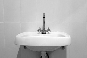 Sink with black and white faucet.	