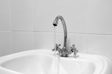 Sink with black and white faucet.	