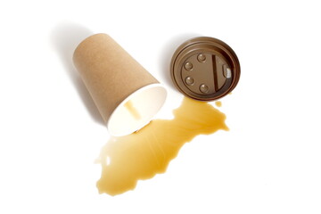 Spilled coffee residue with paper cup lies on white background.	