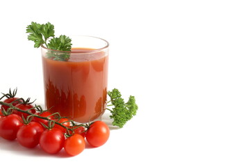 One glass with freshly squeezed tomato juice stands on a white background.	