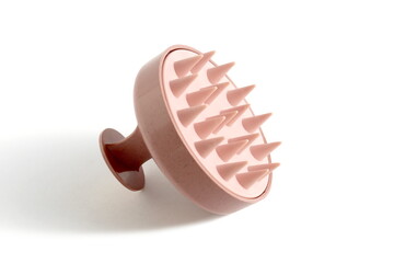 There is a plastic head massager on a white background.