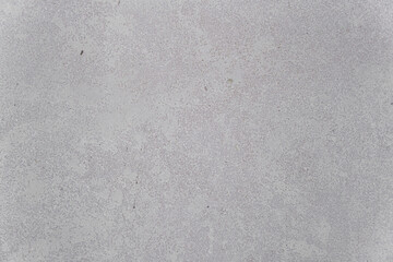 Concrete wall with traces of impacts and cracks. Abstract construction background.