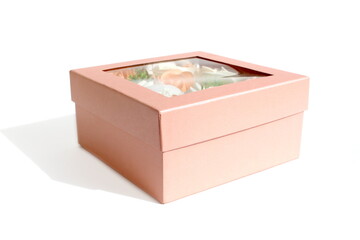 There is a pink box with soap flowers on a white background.