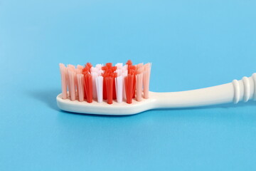 On a blue background lies a new toothbrush.