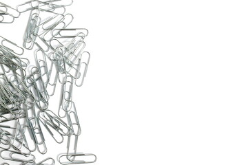 On a white background lies a large pile of twisted paper clips.