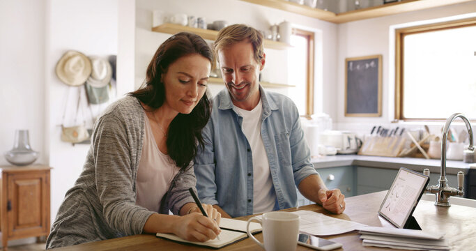 Finance, notebook and couple in home for writing household budget, savings and taxes together. Tablet, financial and man helping woman with diary, investing or mortgage loan for planning in apartment