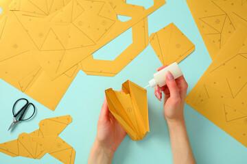 Step-by-step paper model assembly: crafting fun with paper, scissors, and glue