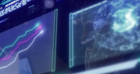 Data analyst studying holographic line graphs in tech control room, displaying world map overlay - Powered by Adobe