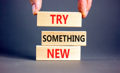 Try something new symbol. Concept words Try something new on beautiful block. Businessman's hand....