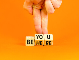 Belonging and belong symbol. Concept words Be here Belong on beautiful wooden block. Beautiful orange background Businessman hand. Business motivational belonging and belong concept. Copy space.