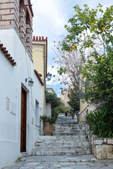 Steps in a narrow alley rise to a hill with ruins