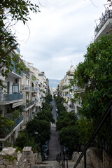 Descent to the street of modern buildings in Athens. Steps. Panoramic view.