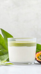 Matcha tiramisu with exotic passionfruit garnish against tropical leaf background